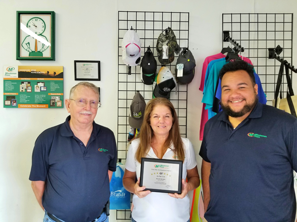 Minuteman Press printing franchise - Susan Olsen and Team pose in store