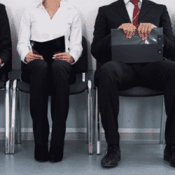 group of people sitting outside office waiting for an interview