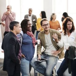 Group of diverse co-workers standing around talking