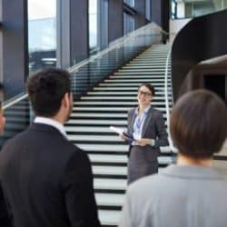 tour guide is showing people around in a large building