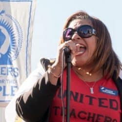 Cecily Myart-Cruz speaks into Microphone at podium during rally
