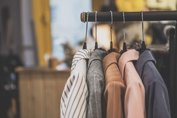 A clothes rack with women's coats hanging on it