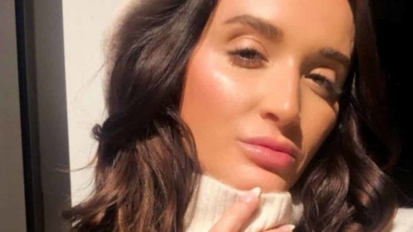 A selfie, or self taken photo, ofMelinda Solares wearing a white turtle neck with little to no make up on in natural bright lighting